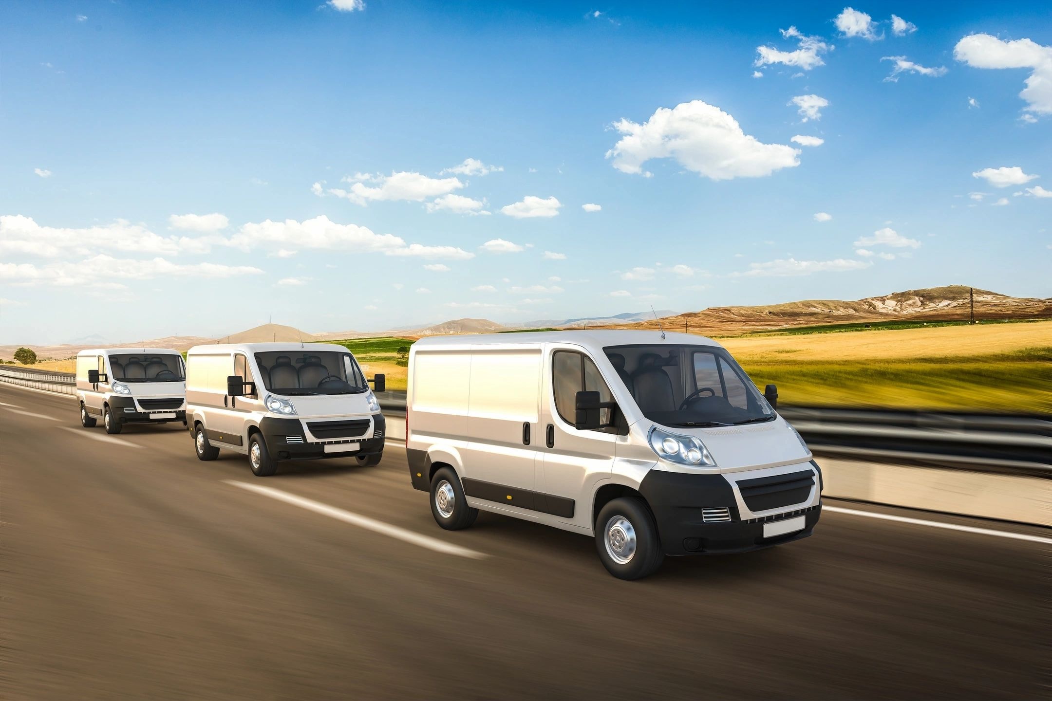 White delivery vans on a highway